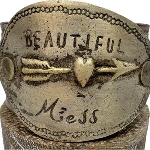 A Rare Bird Brass and Leather Cuff